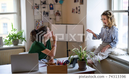 Teenager schoolgirl learning online indoors at home, coronavirus and disturbance concept. 74313396