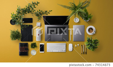 Flat lay top view office desk working space with laptop and supplies on orange background. Flat lay top view office desk working space with laptop and supplies on orange background. 74314873