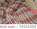 Crumpled white bedclothes top view 74315301