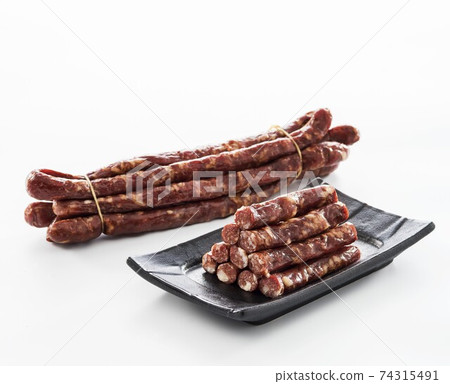 Dried intestines on white background Dried intestines on white background 74315491