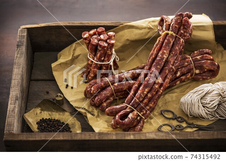 Dried intestines on wooden board Dried intestines on wooden board 74315492