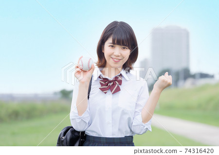High school girl with baseball High school girl with baseball 74316420