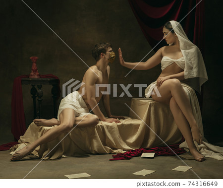 Modern remake of classical artwork with coronavirus theme - young medieval couple on dark background 74316649