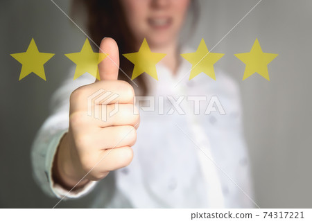 Customer Experience Concept. Woman hand showing on five star excellent rating on background, copy space Female with thumbs up 74317221