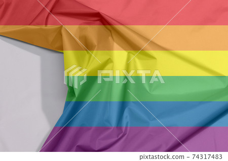 LGBTQ+ fabric flag crepe and crease with white space, red orange yellow green blue purple. 74317483