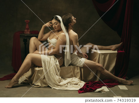 Modern remake of classical artwork - young medieval couple on dark background, comparison of eras concept 74319319