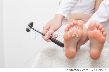 Checking cheddock reflex by a neurologist for the presence of muscle hypertonicity and paralysis diseases, paresis of limbs, copy space Checking cheddock reflex by a neurologist for the presence of muscle hypertonicity and paralysis diseases, paresis of limbs, copy space 74319504