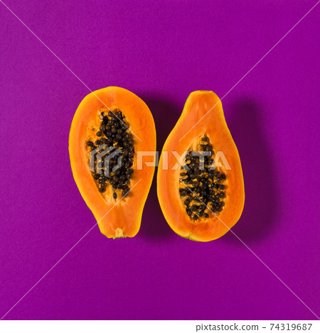 Papaya fruit purple background Creative food flatlay 74319687