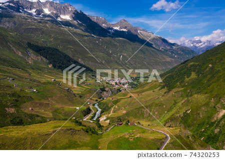 Aerial view of the Realp village and the Reuss river in Switzerland Aerial view of the Realp village and the Reuss river in Switzerland 74320253