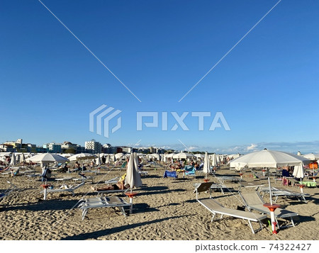 Unidentifiable people in the late afternoon on Caorle beach in Veneto, Italy 74322427