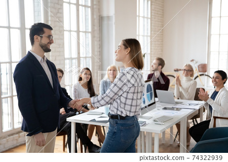 Team leader thanking best employee for work achievements Team leader thanking best employee for work achievements 74322939