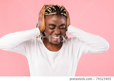 African american woman covering her ears with hands African american woman covering her ears with hands 74323405