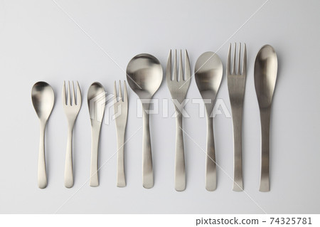 Stainless steel spoon fork cutlery white background 74325781