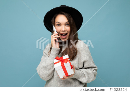 Shot of attractive happy positive amazed young brunette woman isolated over blue background wall Shot of attractive happy positive amazed young brunette woman isolated over blue background wall 74328224