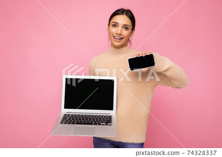 Photo of charming pretty beautiful smiling young woman with dark hair looking at camera holding 74328337