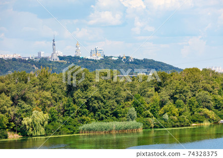 Beautiful summer landscape of the Dnipro islands to the Kyiv hills and the Pechersk Lavra on the horizon. 74328375
