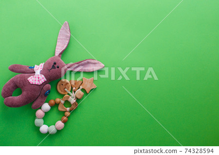 children's toys are laid out on a green background top view. space for text children's toys are laid out on a green background top view. space for text 74328594