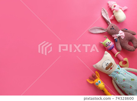 many children's toys are laid out on a pink background top view. space for text many children's toys are laid out on a pink background top view. space for text 74328600