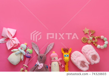 many children's toys are laid out on a pink background top view. space for text many children's toys are laid out on a pink background top view. space for text 74328603