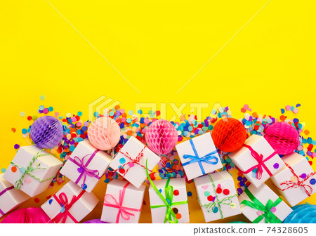 colorful gift boxes on a yellow background top view. 74328605