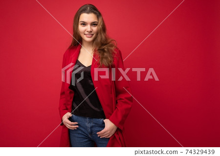 Young beautiful european stylish brunette woman wearing black blouse top and red cardigan isolated Young beautiful european stylish brunette woman wearing black blouse top and red cardigan isolated 74329439