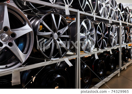 modern store with alloy wheels and tires, indoors in shop modern store with alloy wheels and tires, indoors in shop 74329965