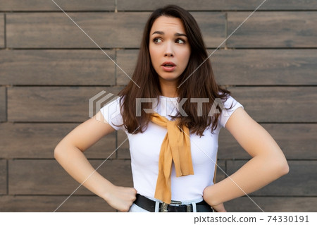 Photo of thoughtful thinking pretty young brunette woman in trendy outfit. Beautiful attractive 74330191