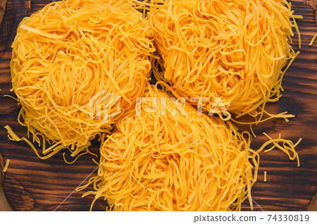 Tagliatelle pasta is thin. Traditional Italian named Angel Hair. Italian egg pasta, homemade and Tagliatelle pasta is thin. Traditional Italian named Angel Hair. Italian egg pasta, homemade and 74330819