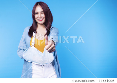 Insurance accident concept. Patient young woman wearing soft splint armband form accident Insurance accident concept. Patient young woman wearing soft splint armband form accident 74331006