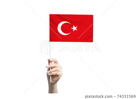 Beautiful female hand holding Turkey flag, isolated on white background 74331569