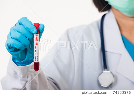 Doctor scientist in white uniform wear a mask holding test tube Coronavirus Doctor scientist in white uniform wear a mask holding test tube Coronavirus 74333576