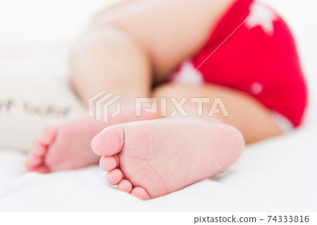 newborn little baby sleeping on white bed at home 74333816