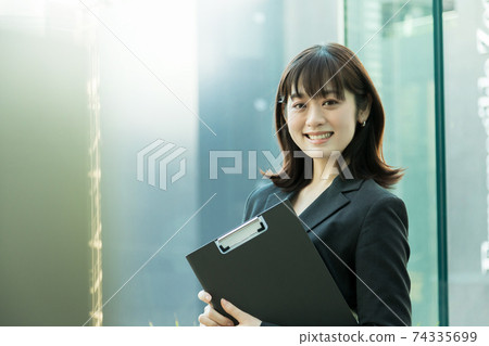 Business woman standing by the window 74335699