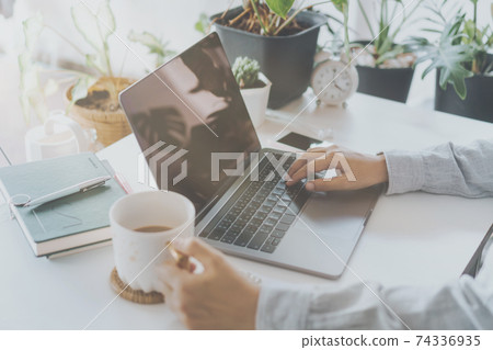 Woman is working on clean nature workspace at home with laptop, planner notebook and calculator. Business finance office. Woman is working on clean nature workspace at home with laptop, planner notebook and calculator. Business finance office. 74336935