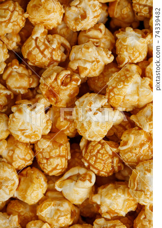 Popcorn in caramel glaze close-up as a background. Popcorn in caramel glaze close-up as a background. 74339482