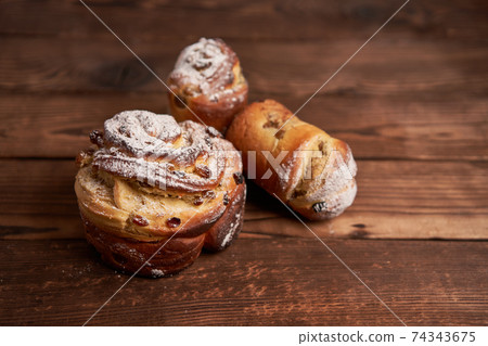 Traditional easter cake Kraffin stands on wooden table against a dark background. Traditional easter cake Kraffin stands on wooden table against a dark background. 74343675