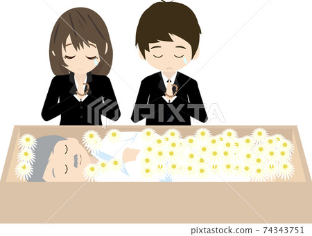 Bereaved family praying for the deceased with flowers 74343751