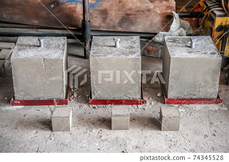 Concrete block cubes with steel bolts for concrete strength testing Concrete block cubes with steel bolts for concrete strength testing 74345528
