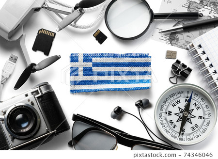 Flag of Greece and travel accessories on a white background. Flag of Greece and travel accessories on a white background. 74346046