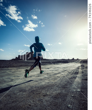 Fitness woman trail runner cross country running on sand desert Fitness woman trail runner cross country running on sand desert 74346826