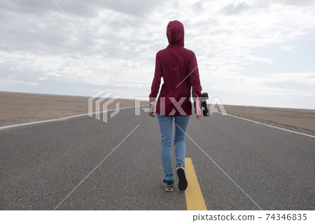Asian woman skateboarder skateboarding in the wide world 74346835