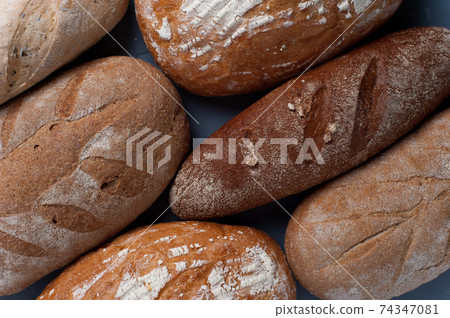 Flat lay bread background. Freshly baked assortment of bread. 74347081