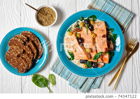 Tuscan salmon stew with rye bread, top view Tuscan salmon stew with rye bread, top view 74347122