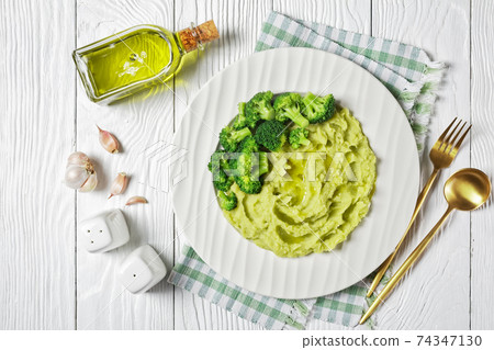 broccoli potato mash on a white plate 74347130