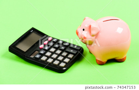 planning and counting budget. moneybox with calculator. planning and counting budget. moneybox with calculator. 74347153