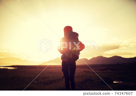 Woman backpacker hiking in high altitude nature 74347607