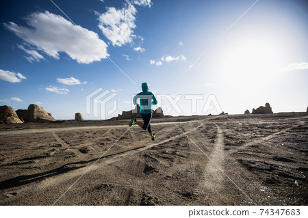 Fitness woman trail runner cross country running on sand desert Fitness woman trail runner cross country running on sand desert 74347683