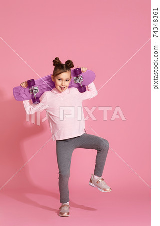 adorable little child girl with pink skateboard 74348361