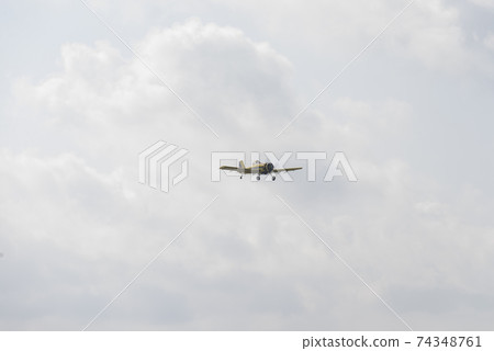 Airplane flying against sky with picturesque clouds. 74348761