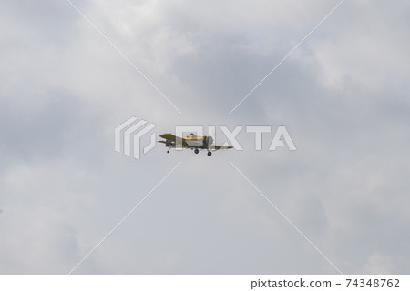 Airplane flying against sky with picturesque clouds. Airplane flying against sky with picturesque clouds. 74348762
